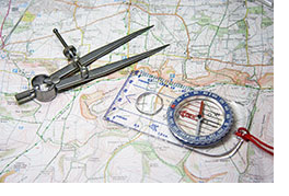 Photo of a map with a compass on top of it.
